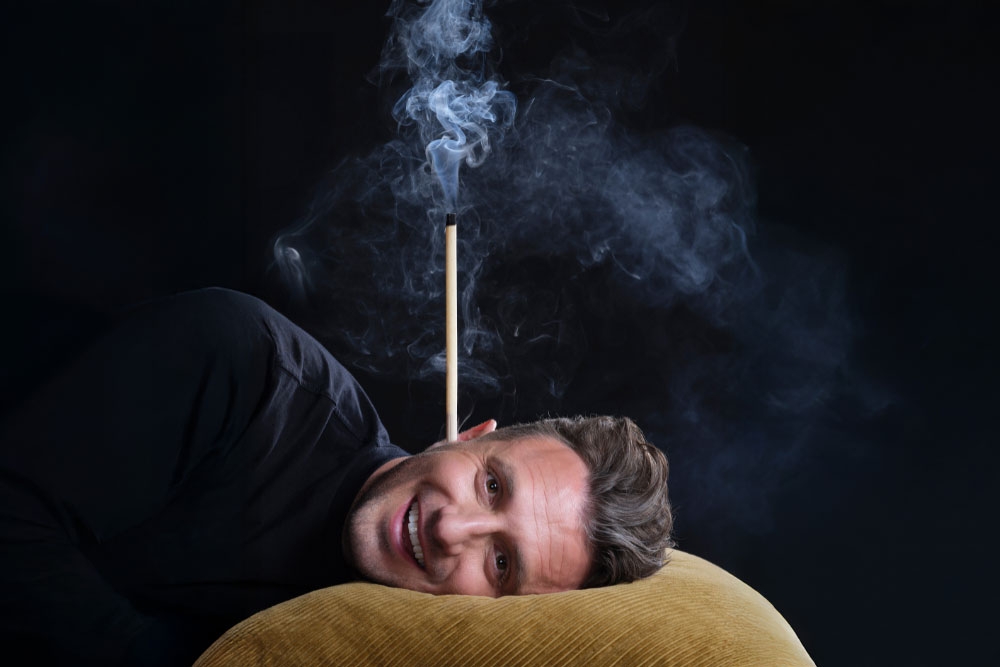 Tiommy Little with incense in ear