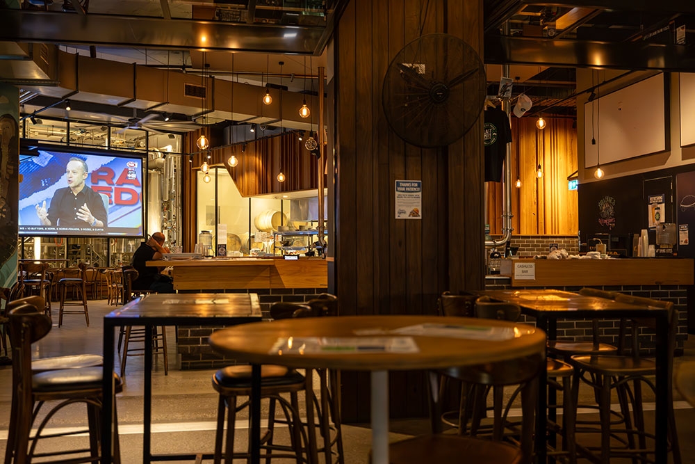 Tables and screen inside Last Man Standing Milton