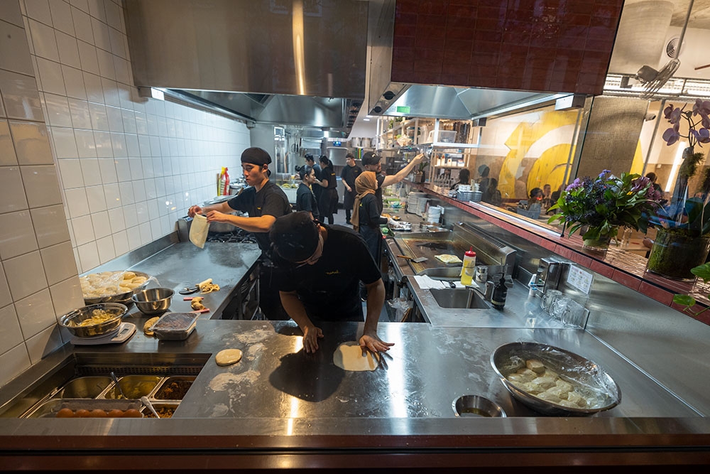 Cooks working inside the kitchen at Mamak Malaysian Roti & Satay Brisbane CBD