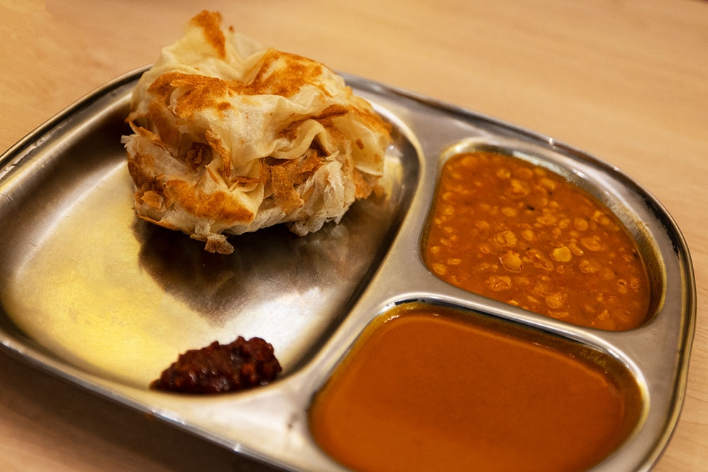 Malaysian roti and sauces on a plate at Mamak Malaysian Roti & Satay Brisbane CBD