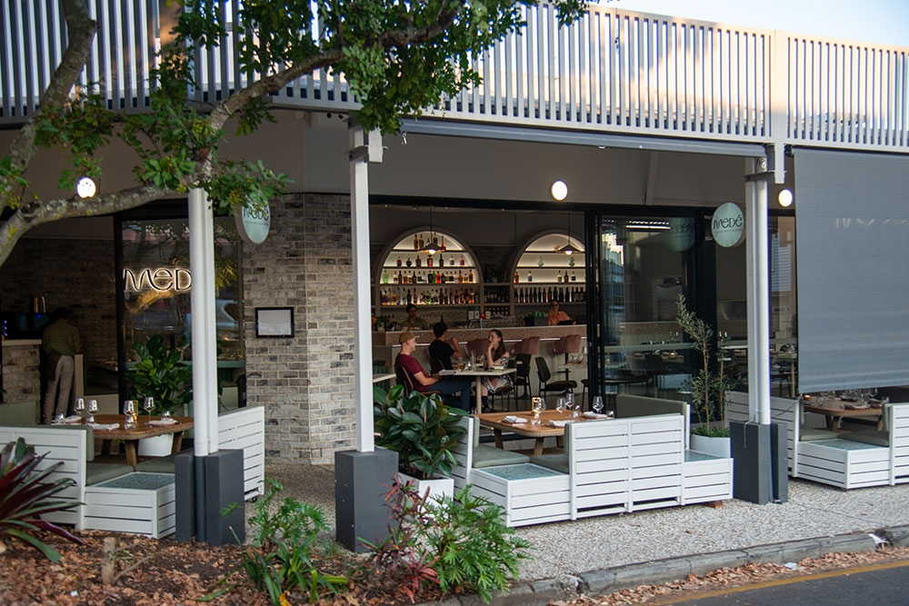 Outdoor seating on footpath at Mede restaurant, Bulimba