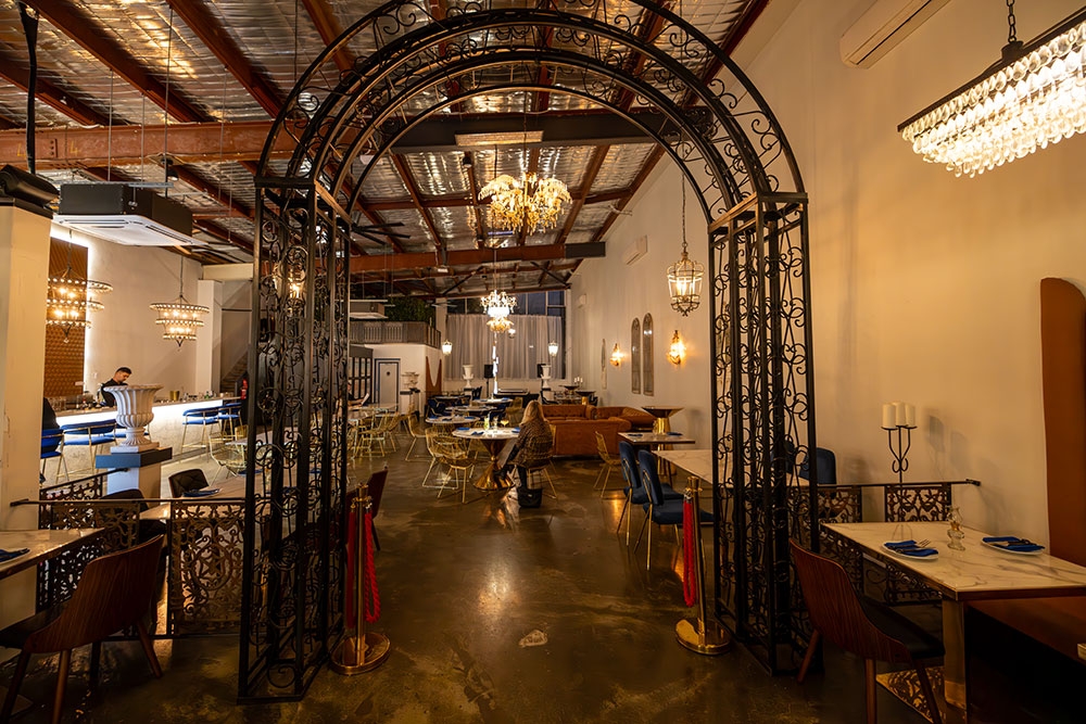 Metal archway leading to bar Miss Manhattan