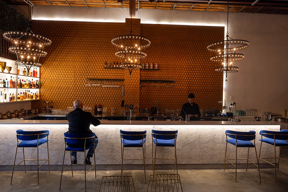 Man seated at bar at Miss Manhattan Newstead