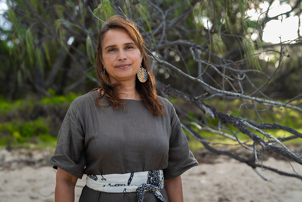 Artist Delvene Cockatoo-Collins on a beach