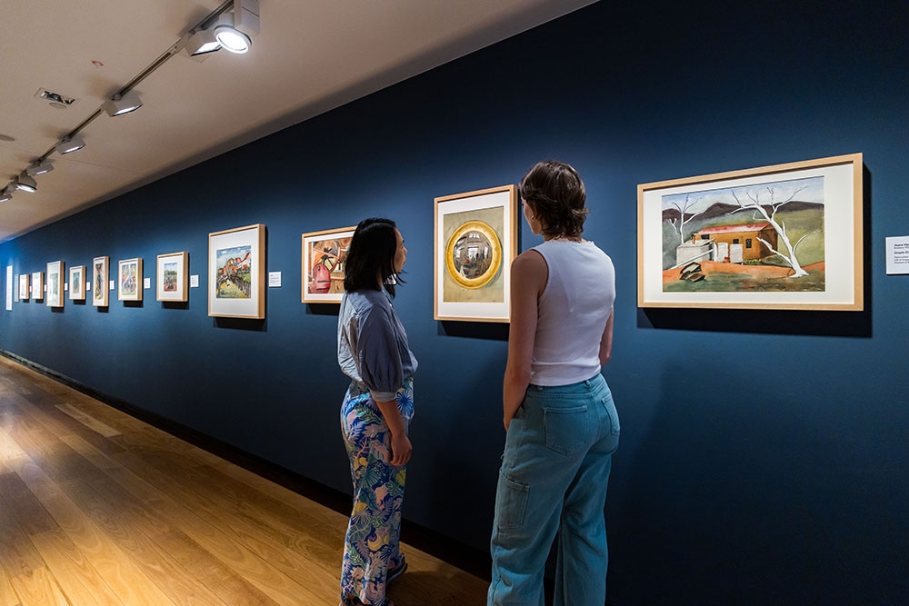 People looking at Cribb Island: Brisbane's Lost Suburb Exhibition at Museum of Brisbane