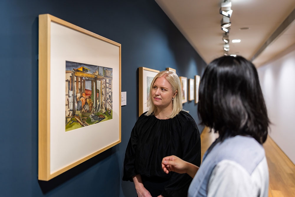People looking at Cribb Island: Brisbane's Lost Suburb Exhibition at Museum of Brisbane