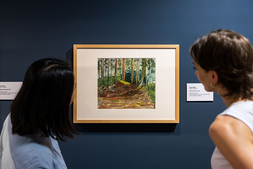 People looking at Cribb Island: Brisbane's Lost Suburb Exhibition at Museum of Brisbane