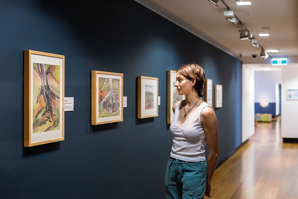 Person looking at Cribb Island: Brisbane's Lost Suburb Exhibition at Museum of Brisbane