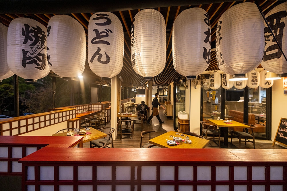 Table and chairs with lanterns hanging from the roof at Mobo Japanese Kangaroo Point