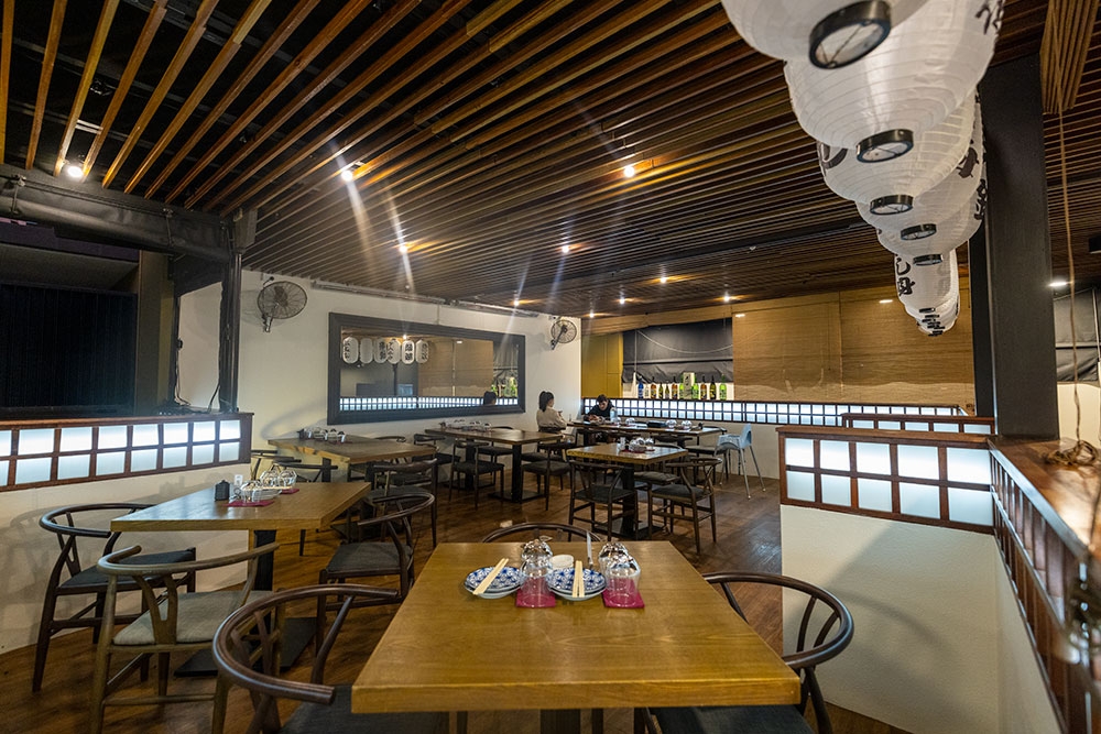 Table and chairs with lanterns hanging from the roof at Mobo Japanese Kangaroo Point