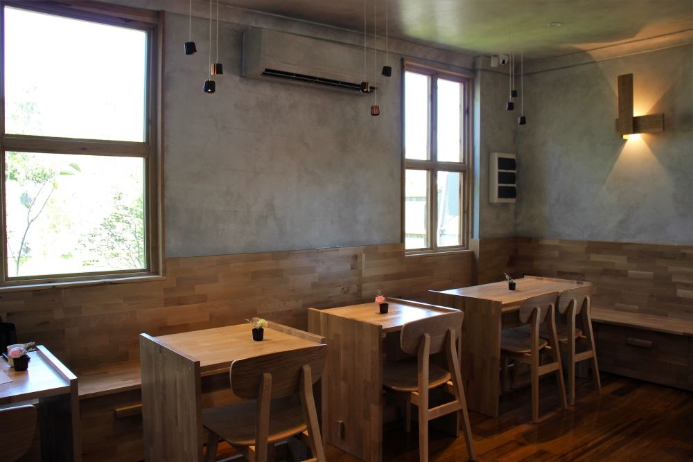 Wooden seating inside Mountain River Patisserie Runcorn