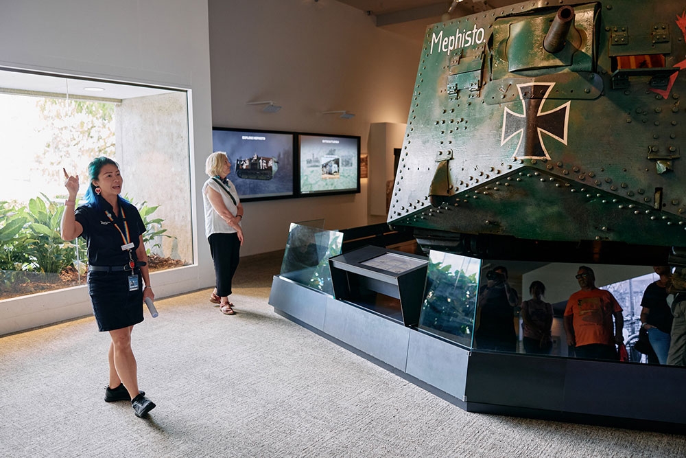 Staff member pointing inside Queensland Museum Kurilpa