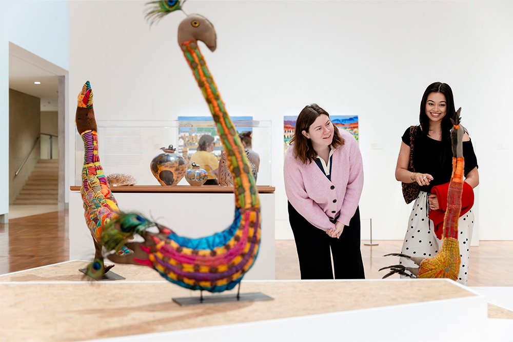 Visitors looking at First Nations artworks 