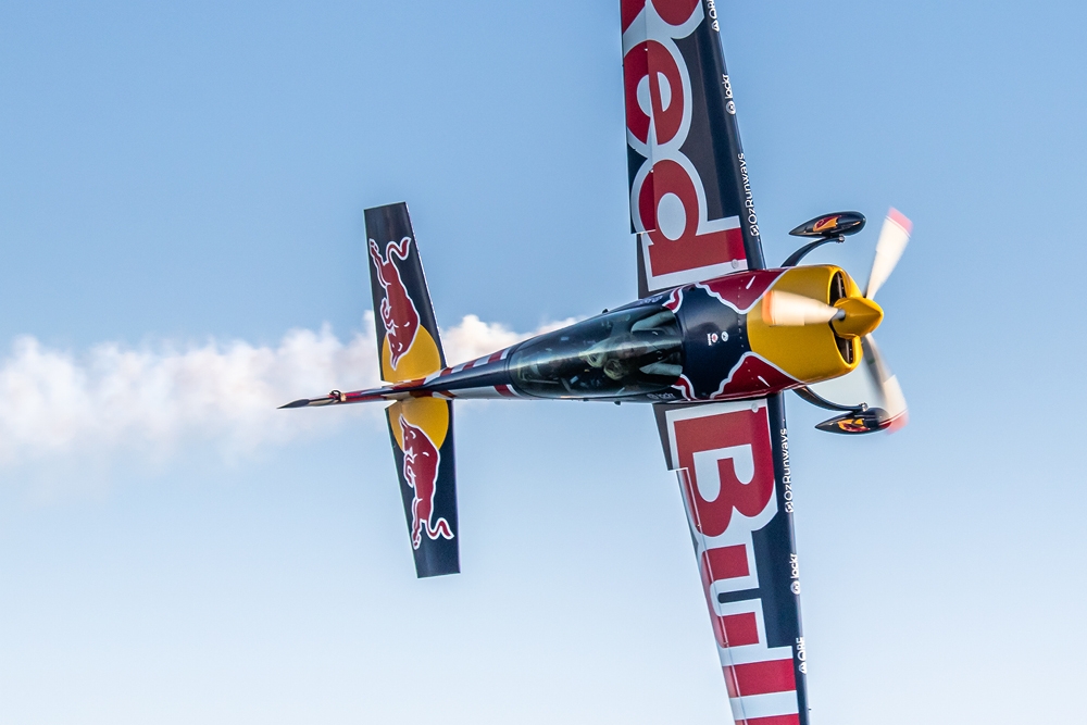 Plane flying above at Planes, Trains And Autos 2026