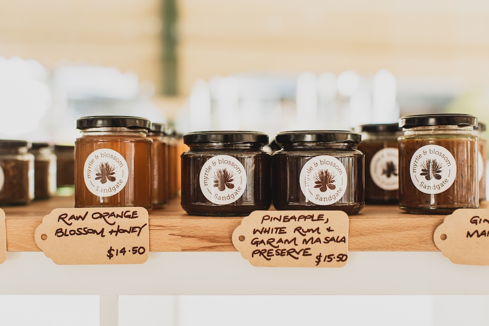 Jars of honey and preserves for sale on a shelf at Myrtle & Blossom, Sandgate 