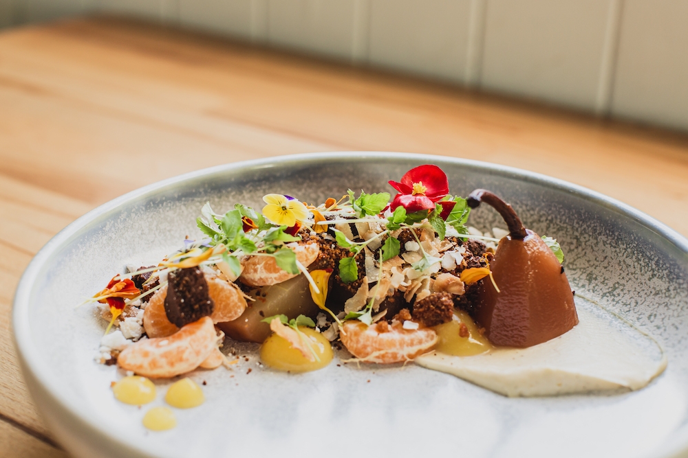 Plate of Hodge Podge and Pear consisting of pear poached in red wine, orange and spices, gingerbread and chocolate crumbs, mandarin, coconut, mascarpone and meringue at Myrtle & Blossom, Sandgate 