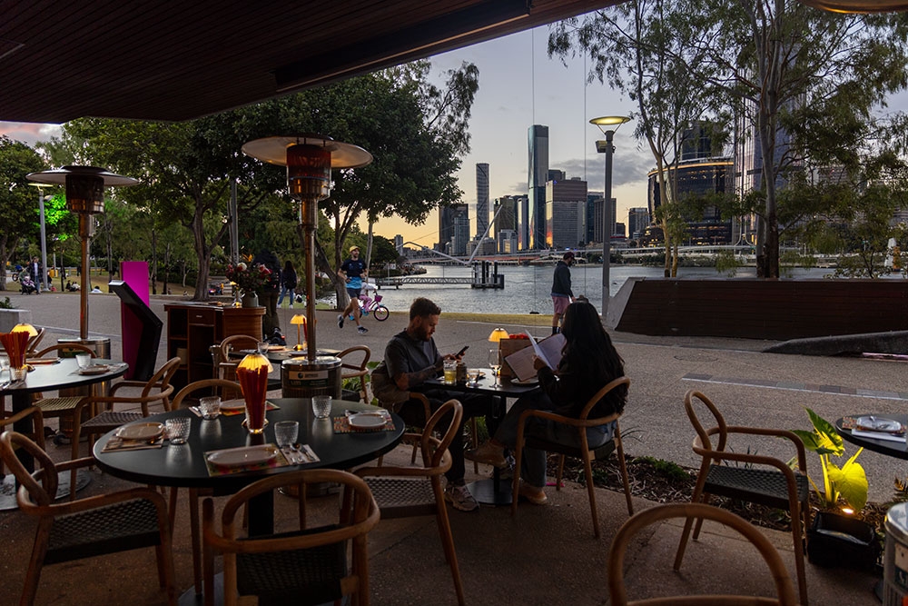 Outdoor seating with a riverview at Naga Thai South Bank