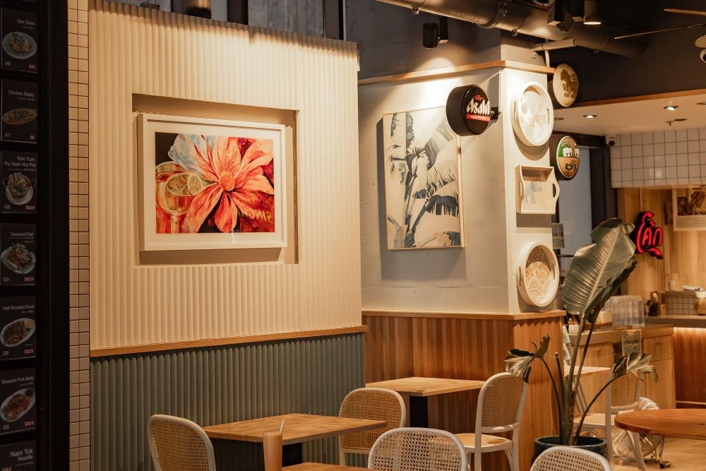 Tables and chairs inside New Season Asian, Brisbane at night