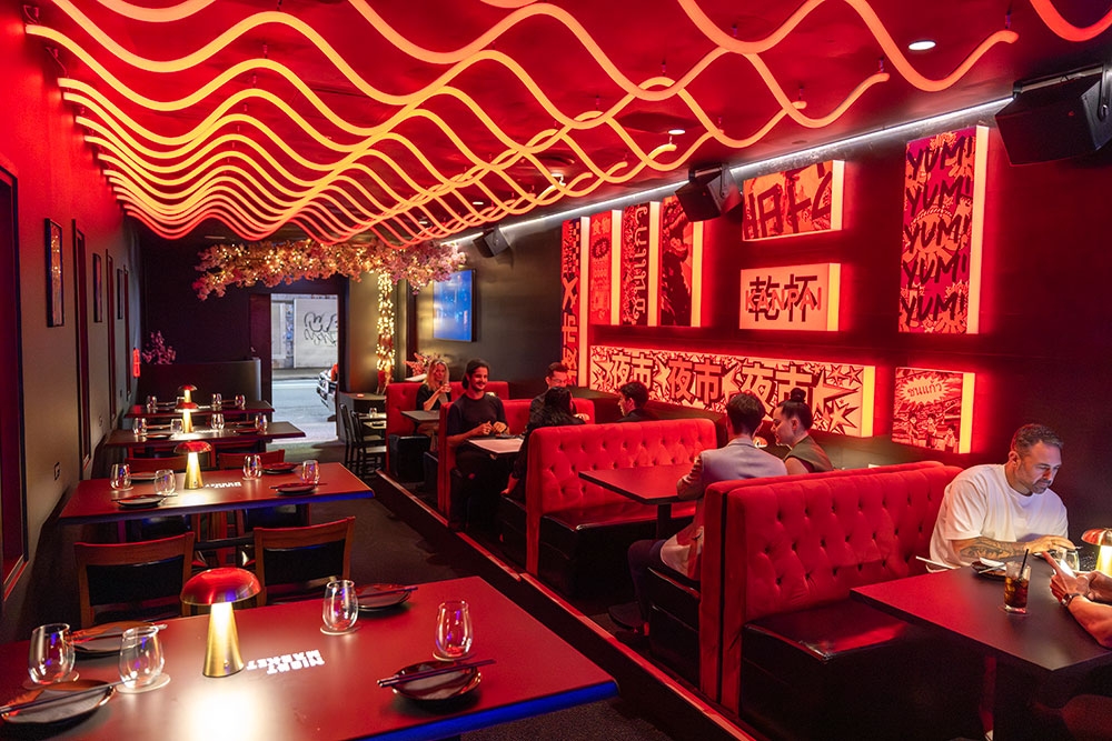 Diners seated in booths along wall Night Market
