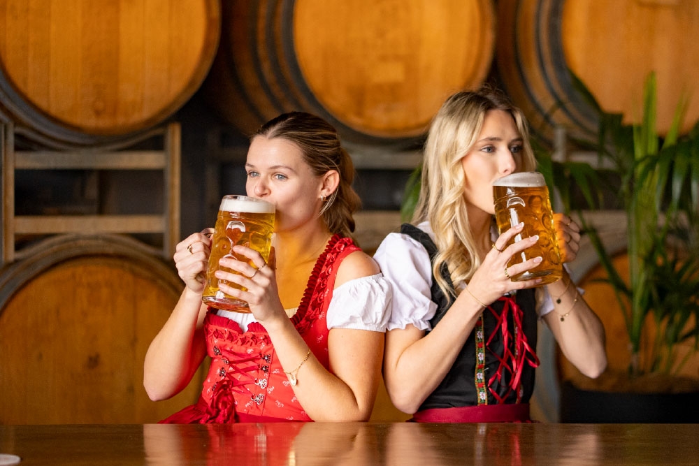 Women drinking beers at Oktoberfest at The Hills