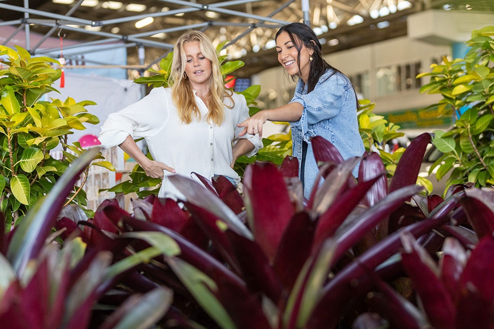 Two women looking at plants at the Plantapalooza Plant Festival