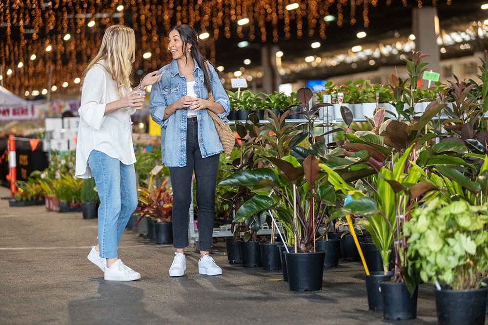 Two women talking to each other at the Plantapalooza Plant Festival