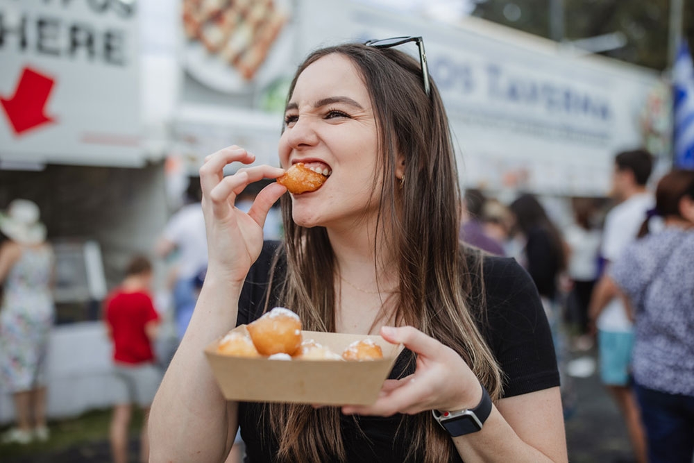 Festivalgoer with food at Paniyiri Greek Festival 