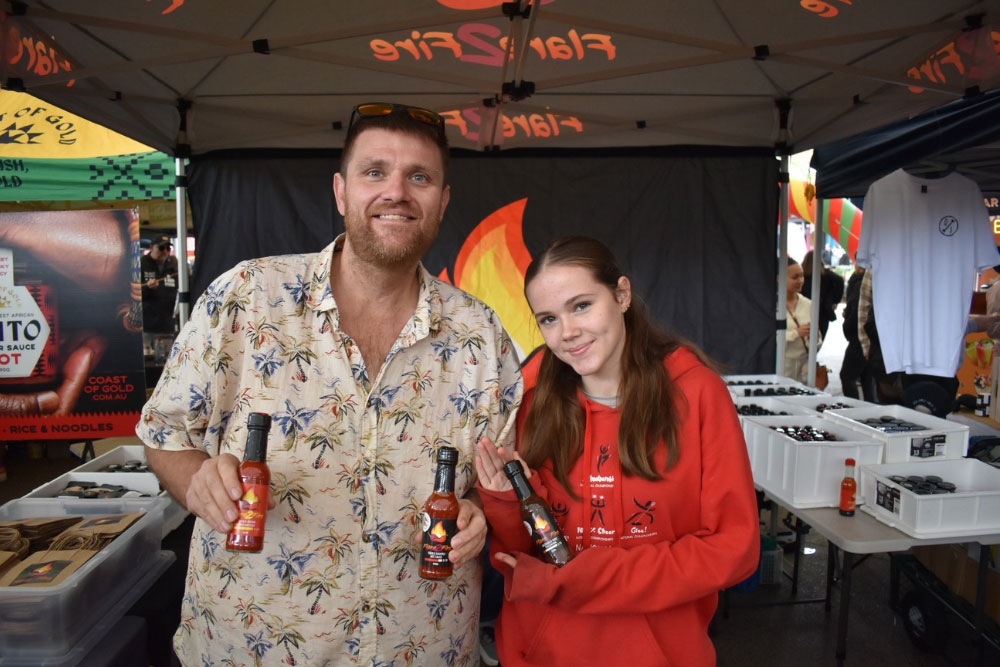 Couple holding sauce bottles 