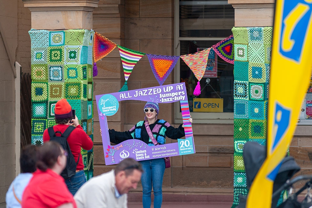Person holding sign at Jumpers & Jazz