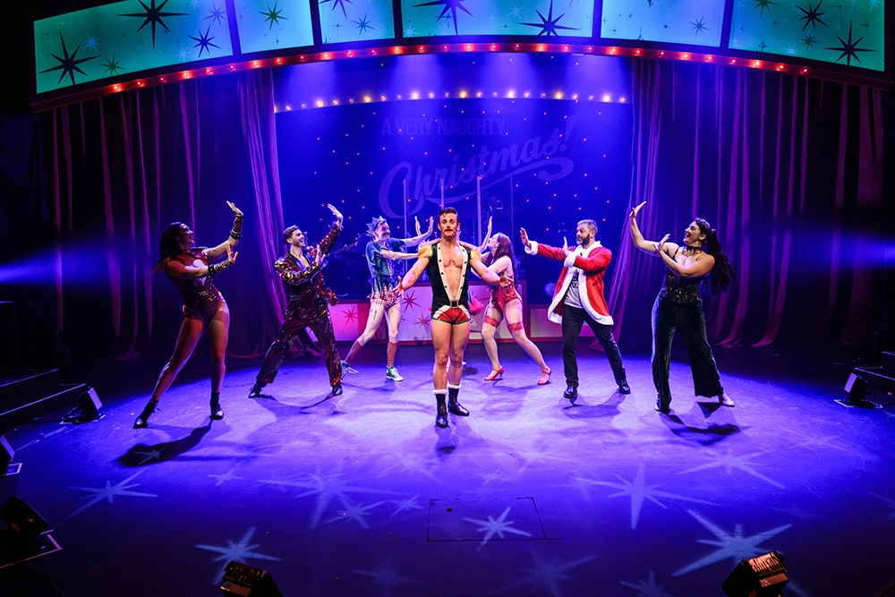 Performers on stage at A Very Naughty Christmas Twelfth Night Theatre