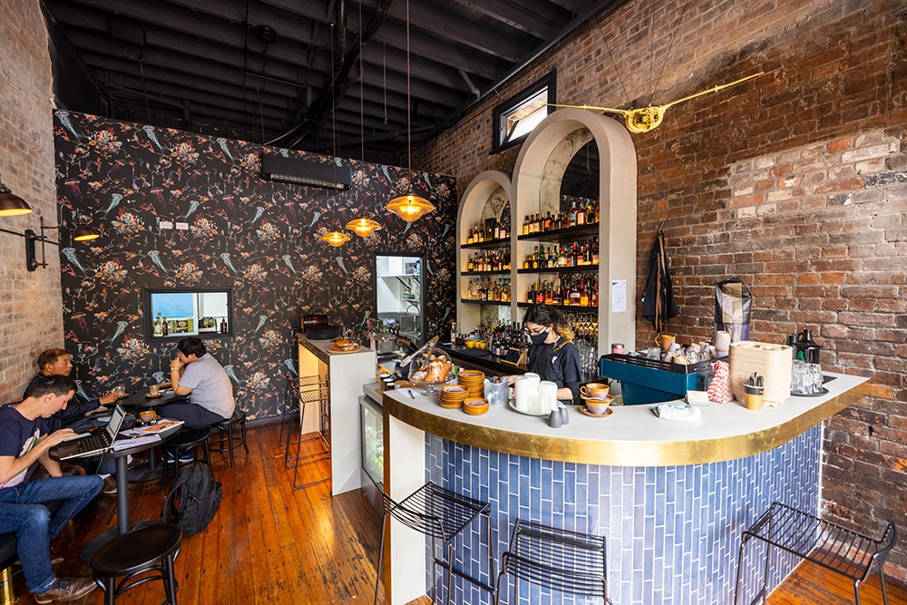 Men sitting at a table next to bar inside Fables Bar & Cafe Woolloongabba