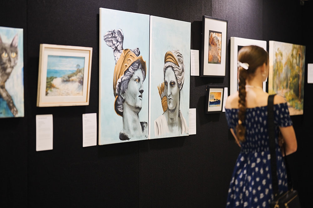 Person looking at artworks Recovered Futures Art Exhibition Brisbane City