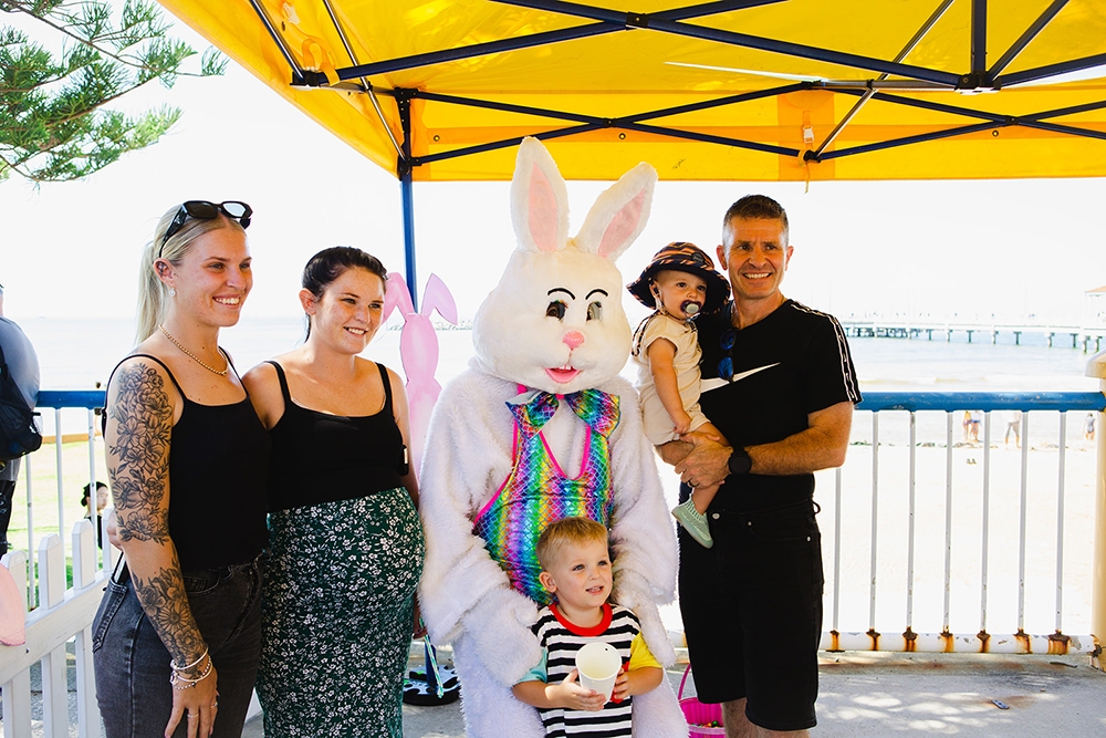 Easter Bunny character with a family at the Redcliffe Markets Easter Extravaganza