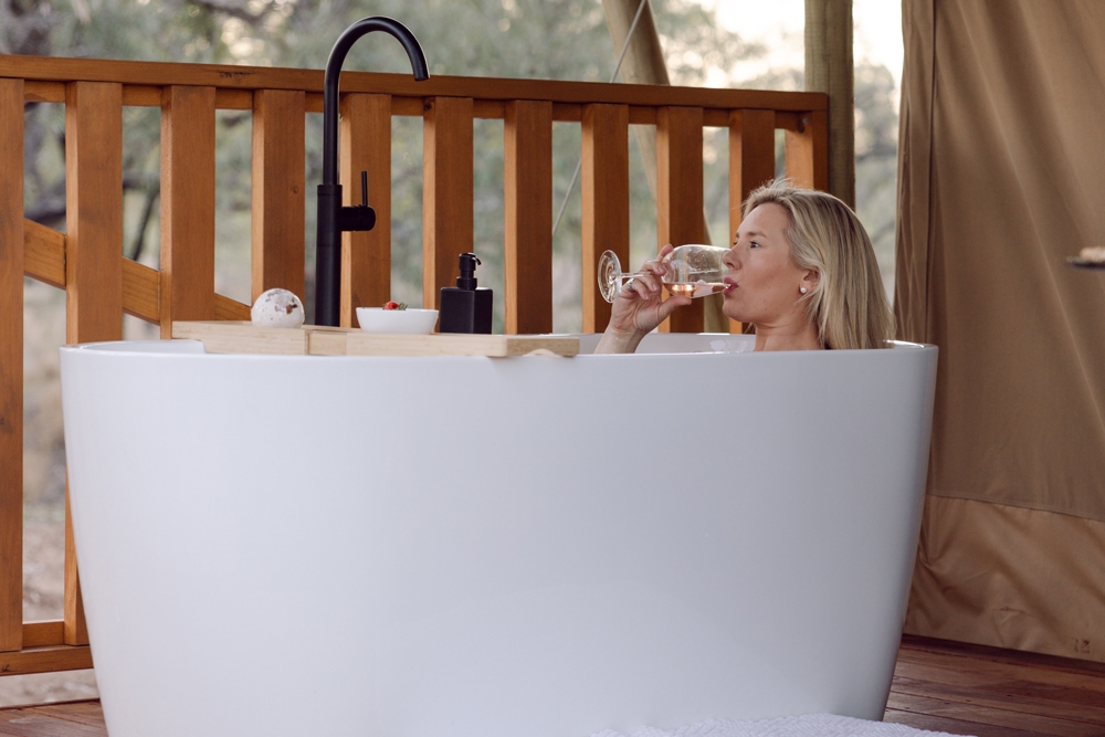 Woman in bath at Riverbank Glamping Chinchilla 