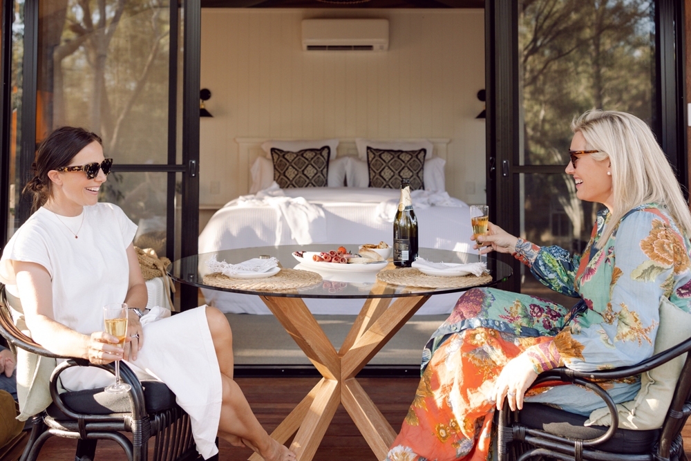 People dining on deck at Riverbank Glamping Chinchilla 