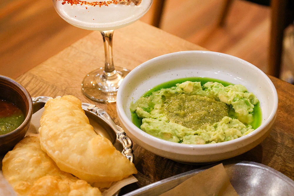 Plate of guacamole and a margarita 