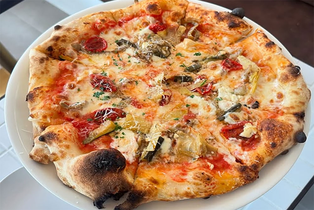 Pizza on table at Olli Italiano
