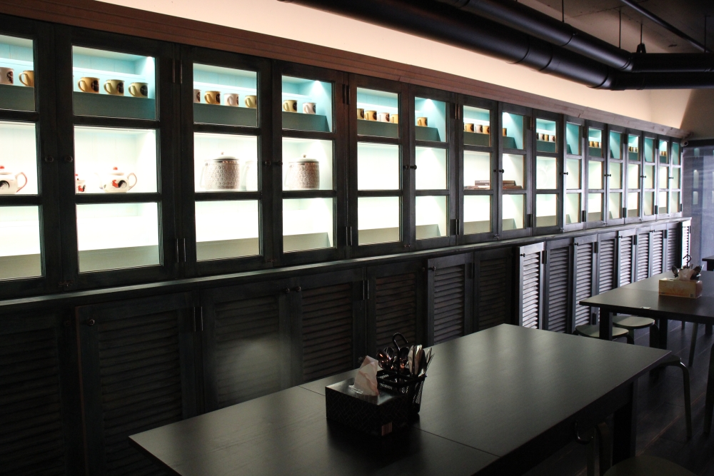 Tables against black walls inside Sendok Garpu, Brisbane