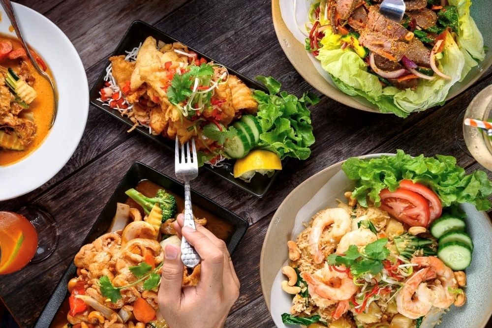 Plates of Thai food being eaten with a fork at Siri Thai Alderley