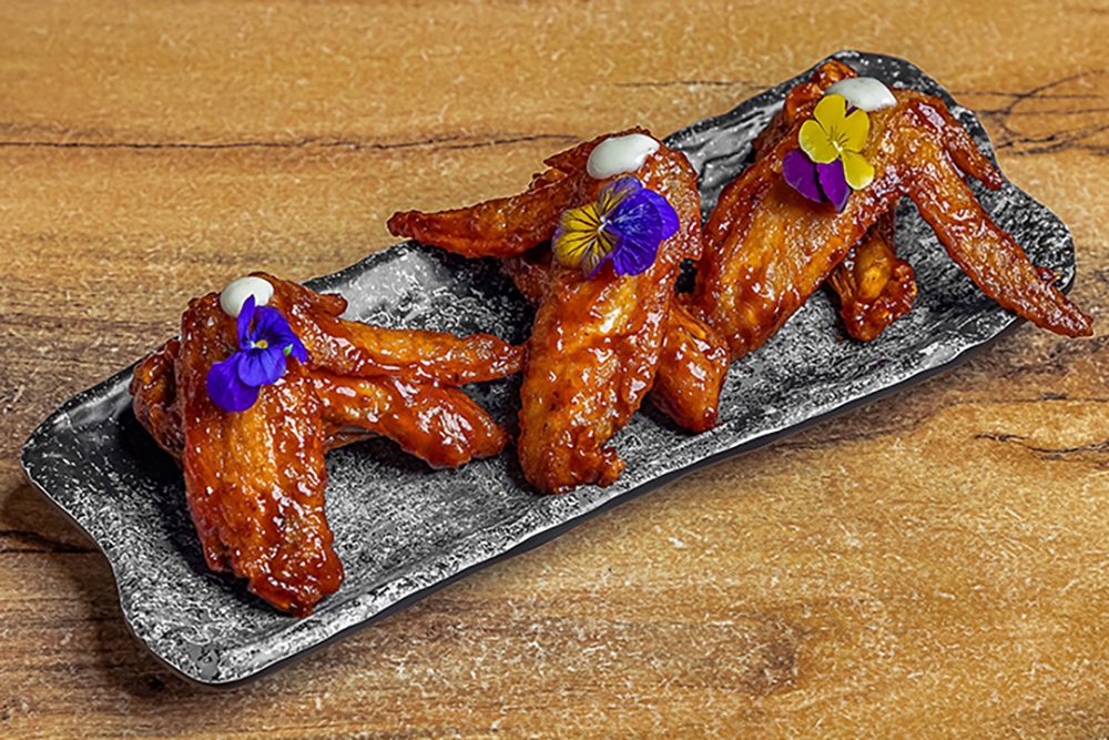 BBQ basted wings on grey plate at Smokehouse Meat & Co South Bank