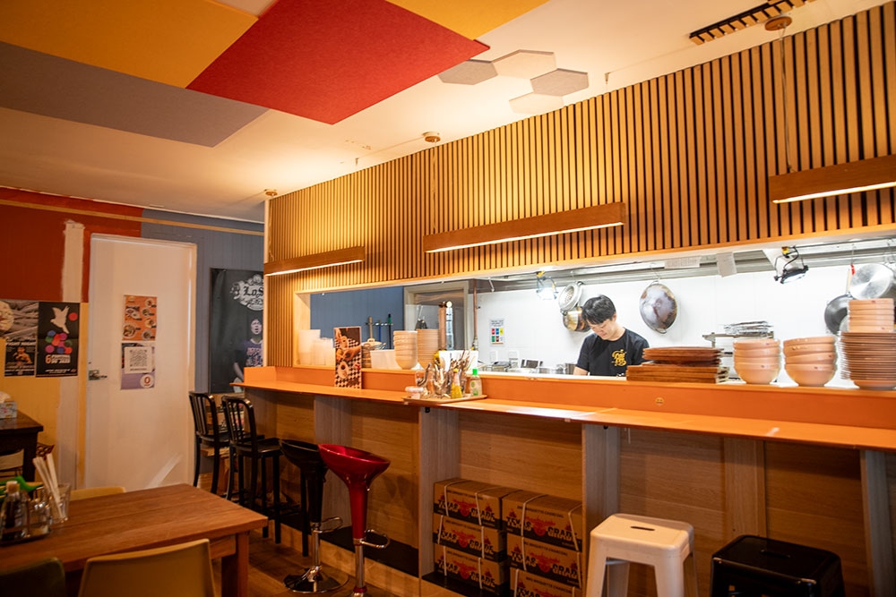 Chef working in kitchen at So What Stereo 