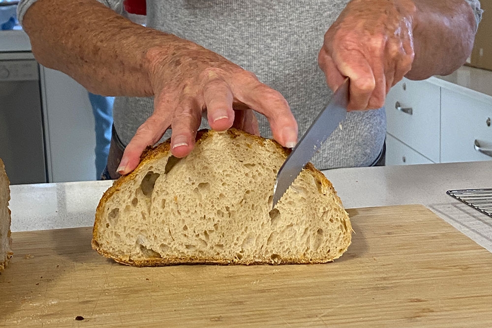 Cutting loaf of sourdough bread