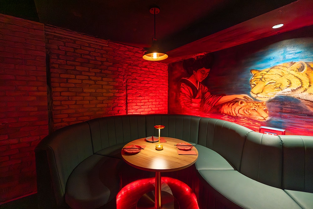 booth with artwork on wall Spice Nightlife