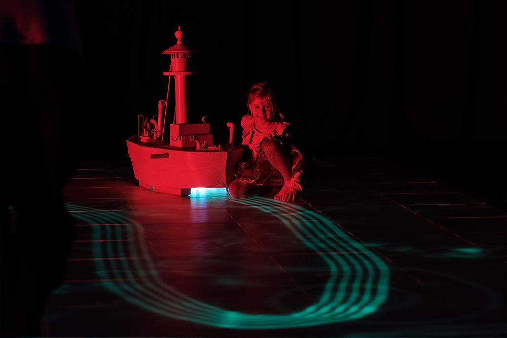 Child with lit up boat