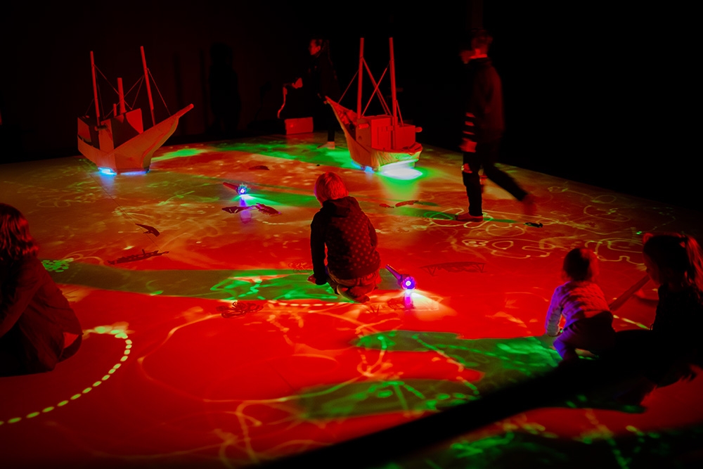 Children playing in light projections
