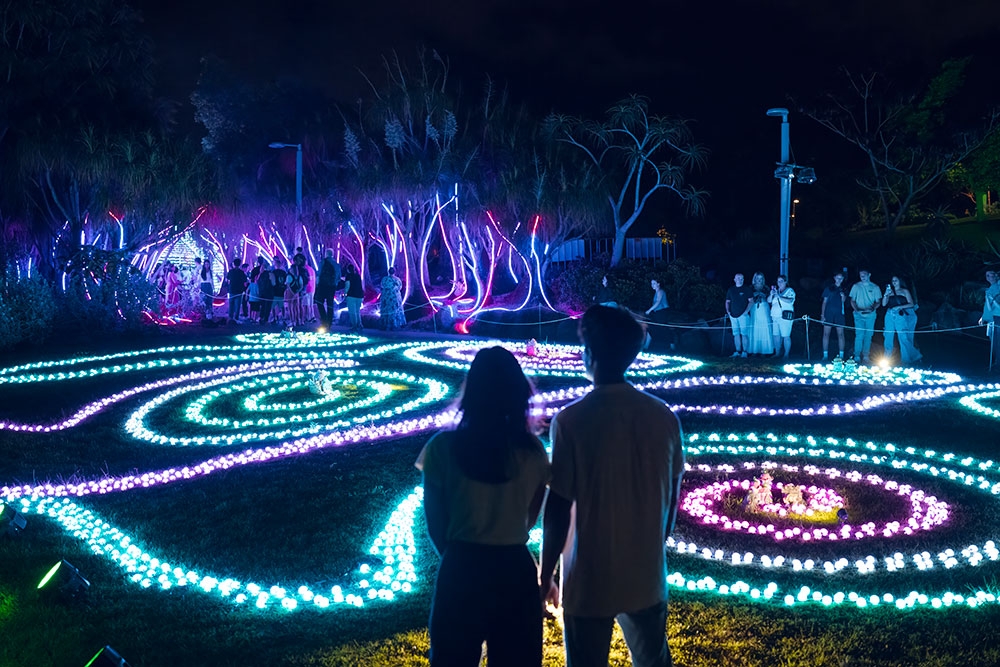 Couple looking at lights The Enchanted Garden