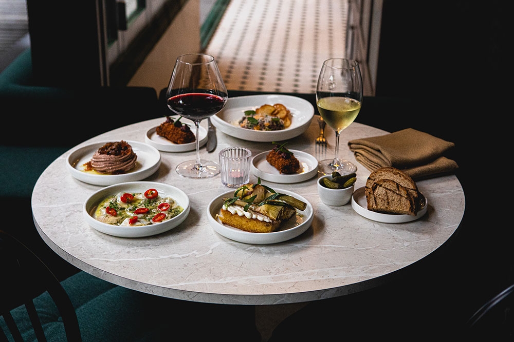 Plates of food on a round table at South City Wine Bar Woolloongabba