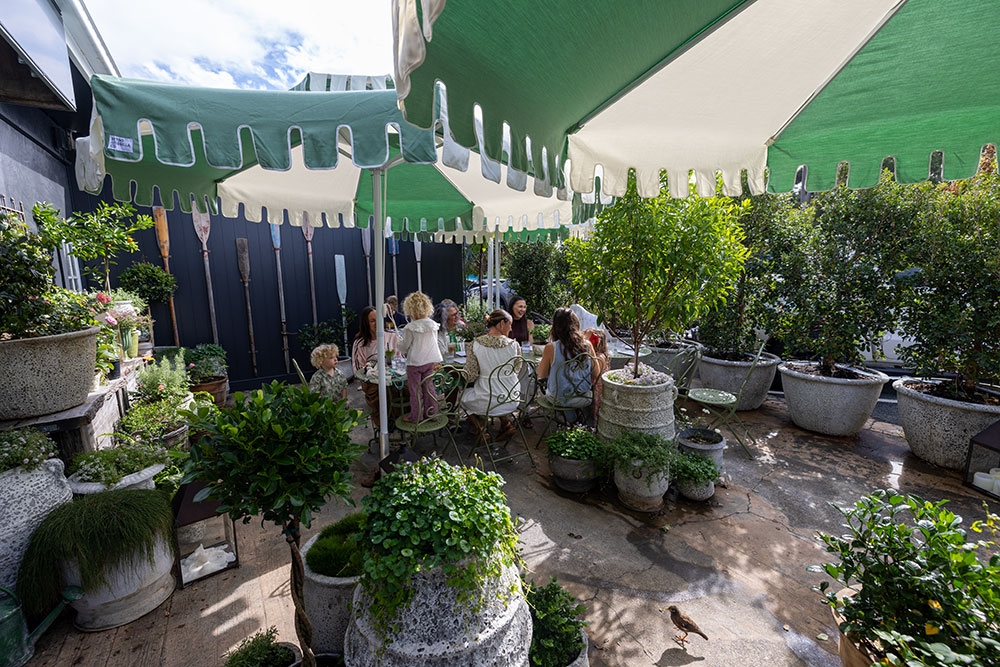 Customers seated in garden at Tarte Tea Garden