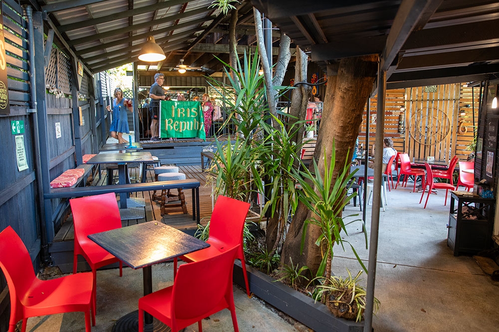 Red chairs and table in  Front Yard Bar Auchenflower