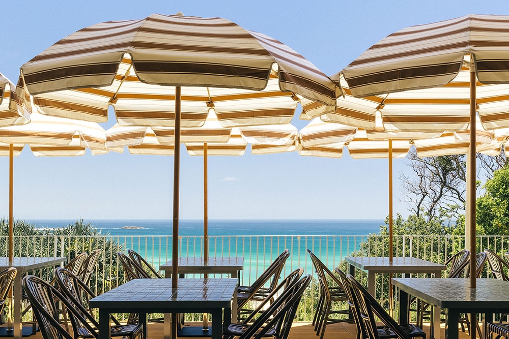 Beach umbrellas and table outside The Straddie Hotel, North Stradbroke Island